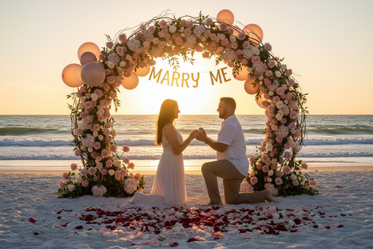 an image of a marriage proposal with a couple on the beach in florida with a big arch or background of flowers and balloons or rose petals all over with the words love or marry me and him on one knee